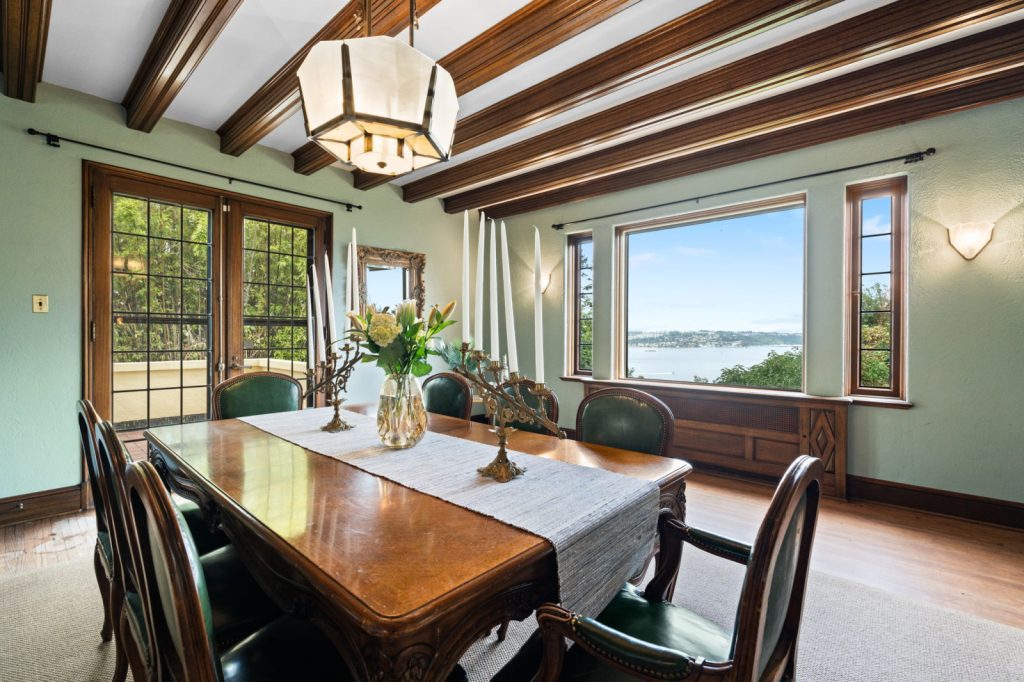 Real Estate Photography Services: Capture the essence of a picturesque dining room, adorned with charming wooden beams and showcasing a mesmerizing view of the water.