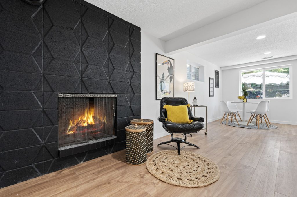 Real Estate Photography Services for a living room with a black fireplace and yellow chair.