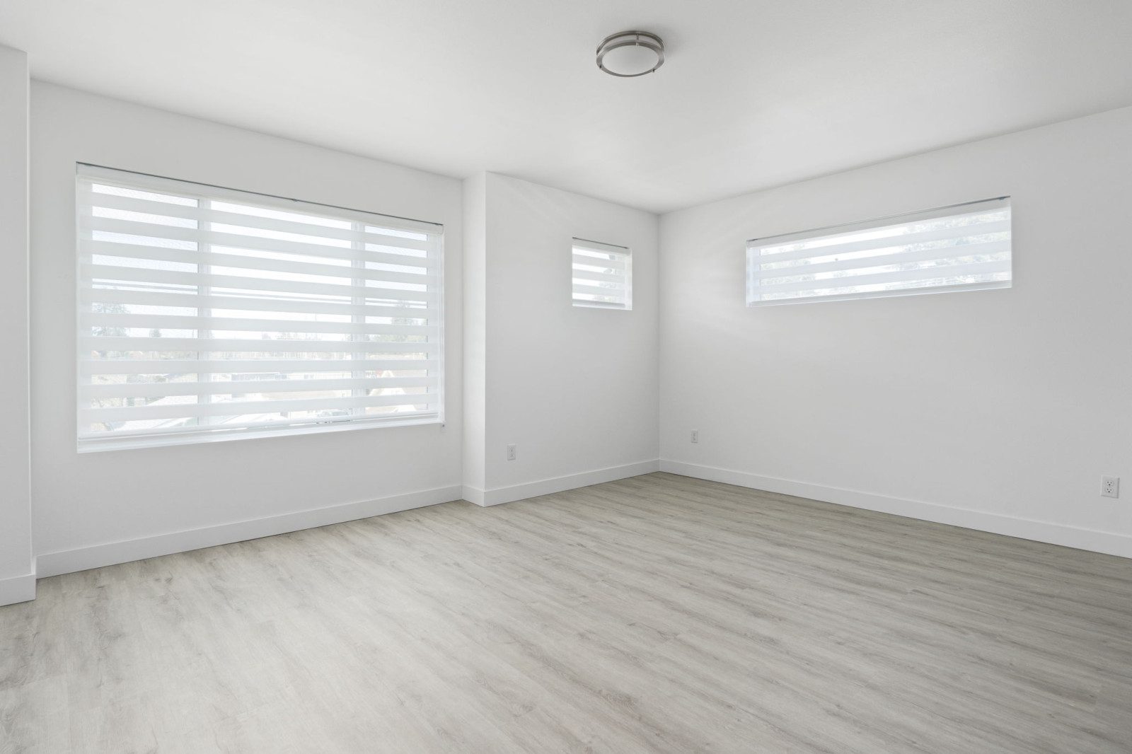 Virtual Staging Solutions now offers an empty room with white walls and wood floors ready for customization.